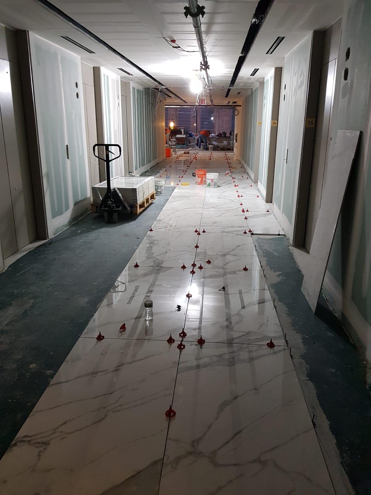 Commercial large-format floor tile installation in progress