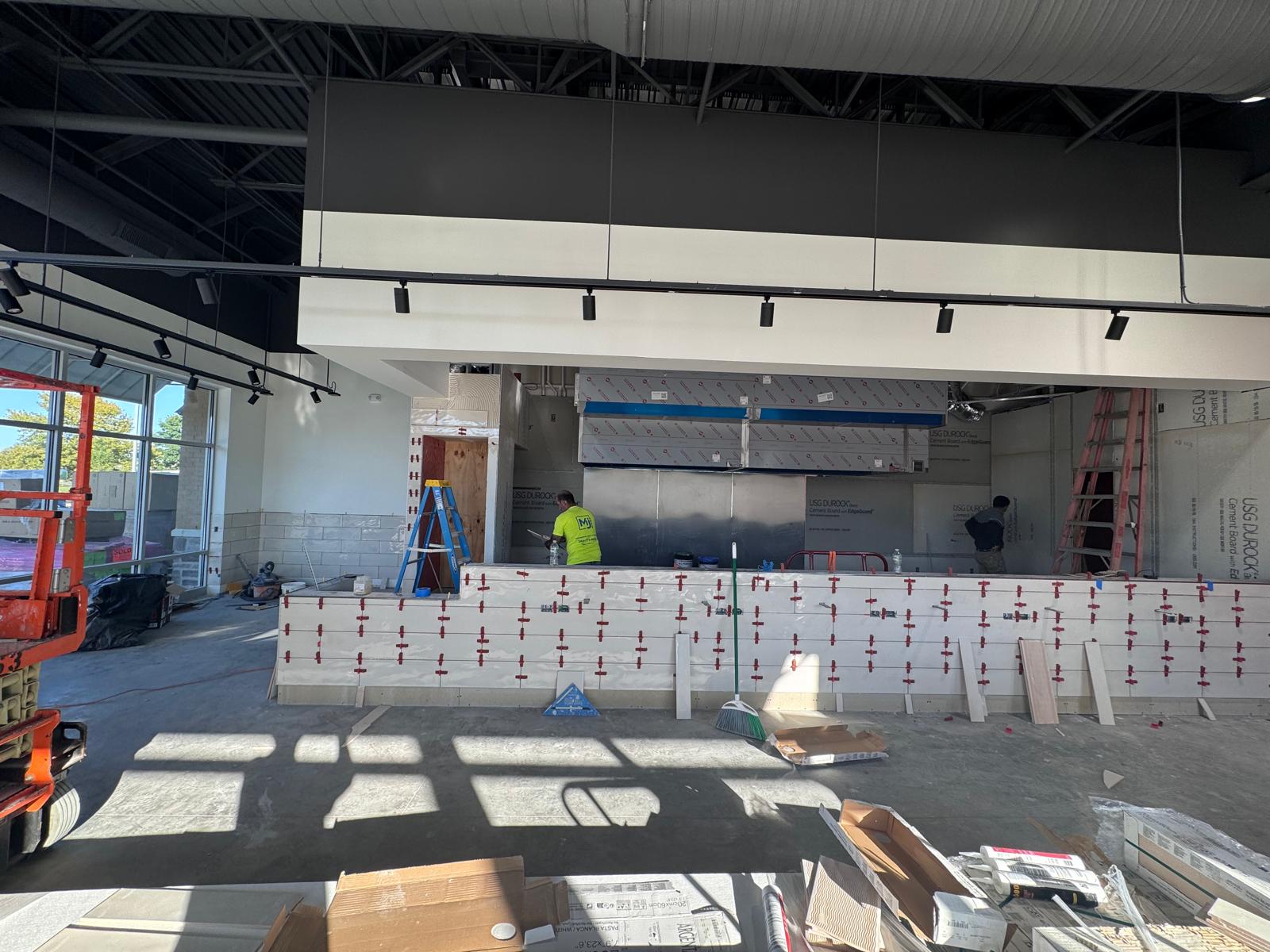 Tile installation underway on the Honeygrow Freehold service counter