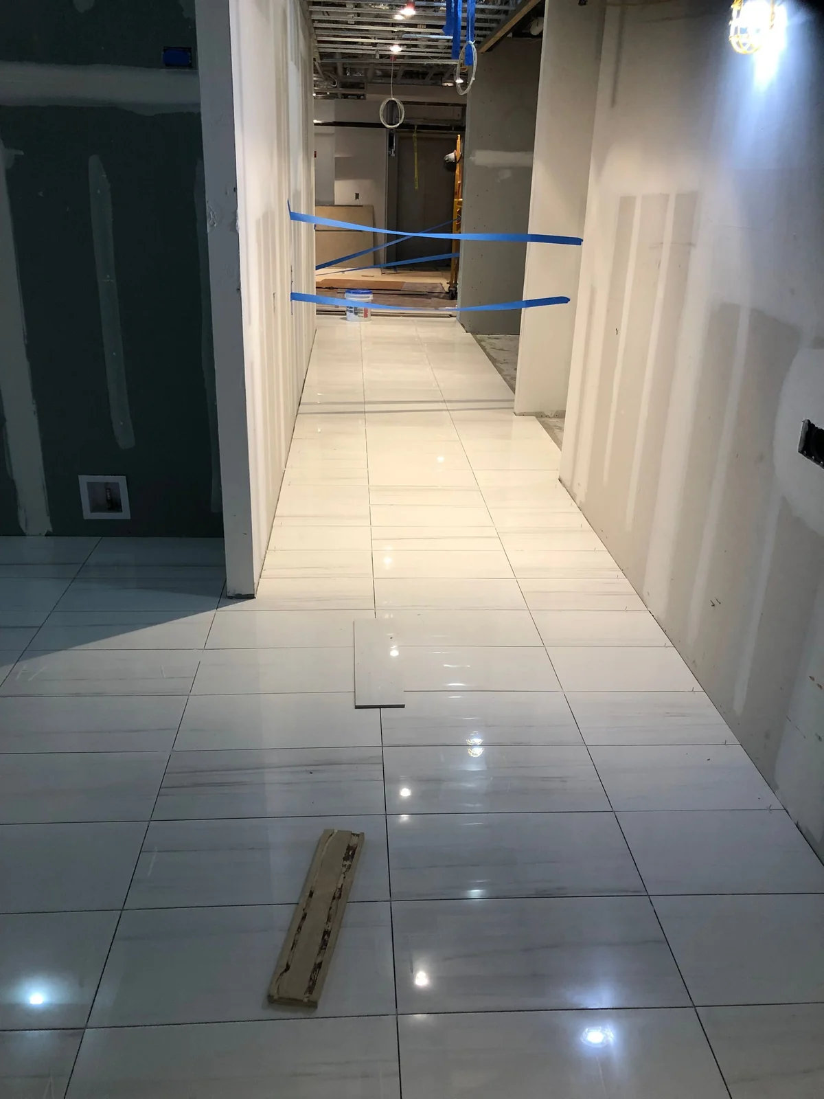 Long commercial hallway with tile floor installation