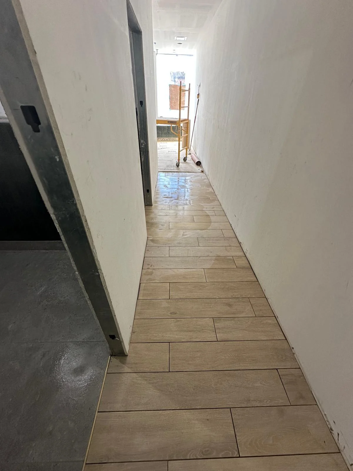 Wood-look plank tile corridor at Wonder