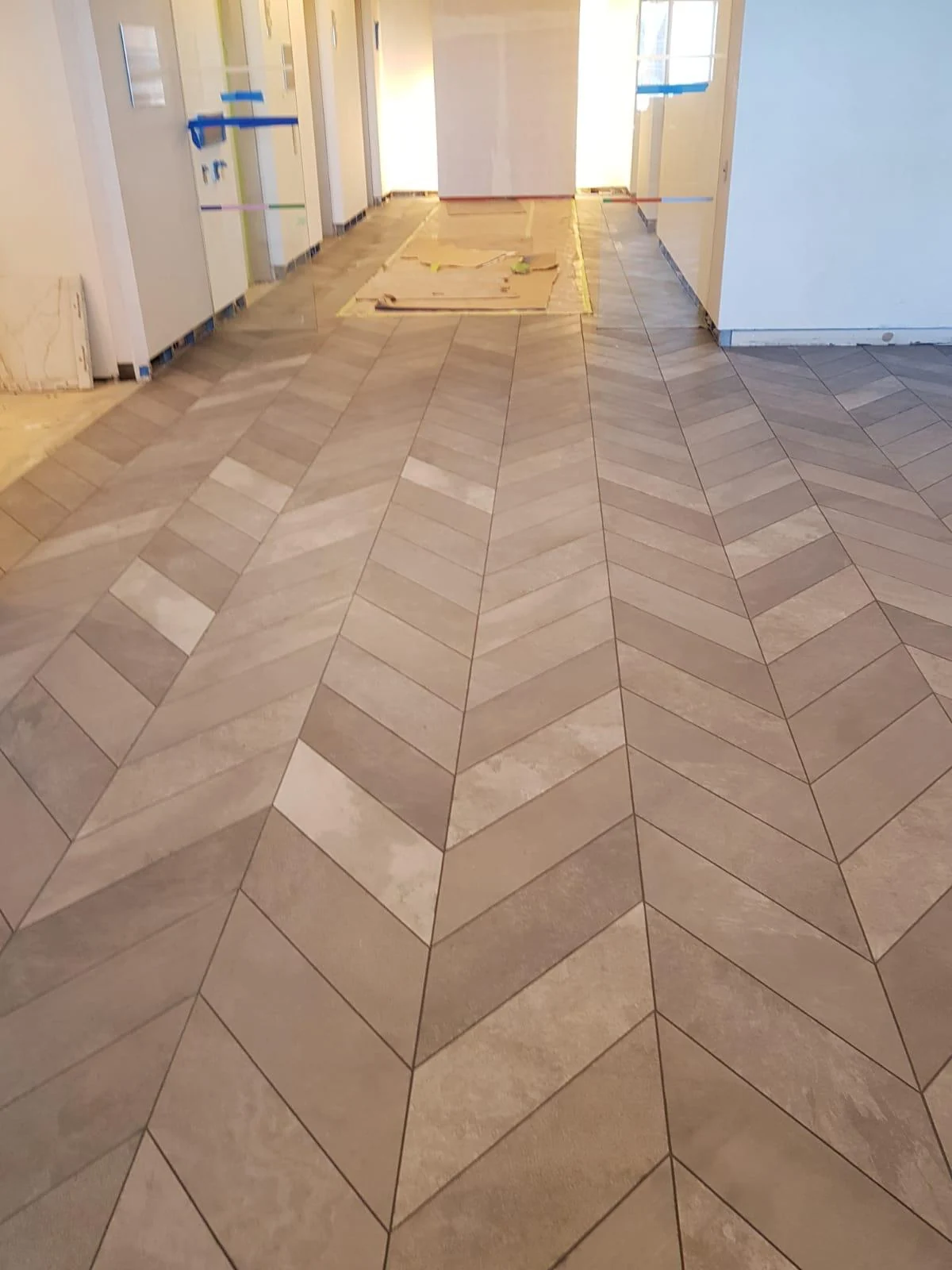 Chevron floor tile installation in private interior