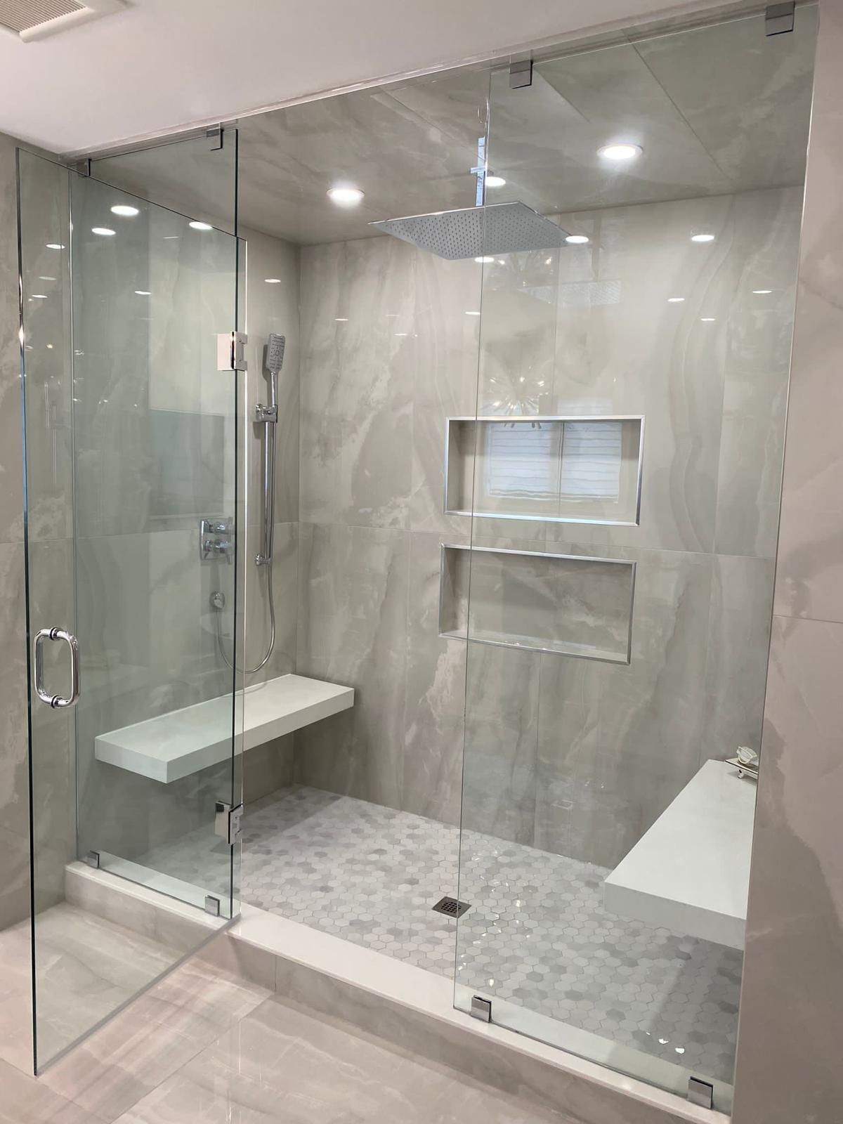 Residential shower tile installation with niche and bench